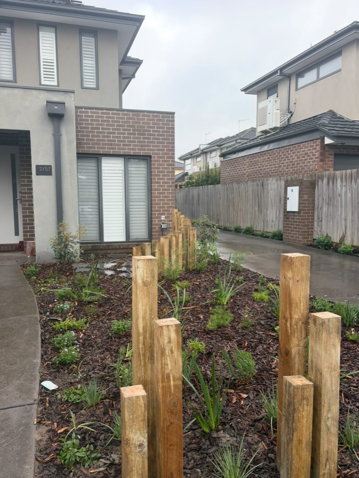 Garden bed with layered planting and timber posts
